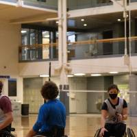 Woman dribbling a basketball in a wheelchair basketball game.